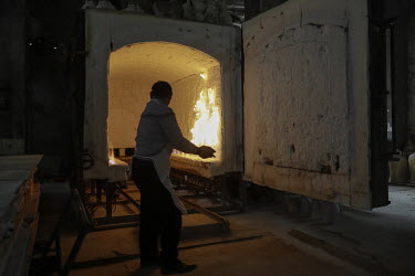 A firing kiln is prepared for use inside a workshop at the Jingdezhen Porcelain Factory.