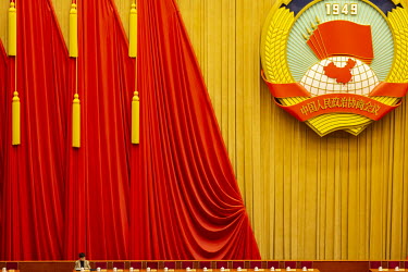A lone attendee sits on stage inside the Great Hall of the People ahead of the opening of the first session of the 13th Chinese People's Political Consultative Conference (CPPCC).