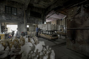 Busts of former Chinese leader Mao Zedong sit on a cart before being loaded into a furnace for firing in a workshop at the Jingdezhen Porcelain Factory.