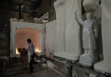 Busts of former Chinese leader Mao Zedong sit on a cart before being loaded into a furnace for firing in a workshop at the Jingdezhen Porcelain Factory.