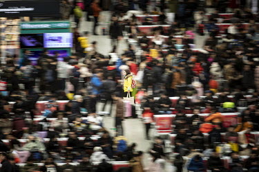 A traveller carries her luggage through the main hall of the Shanghai Hongqiao Railway Station.