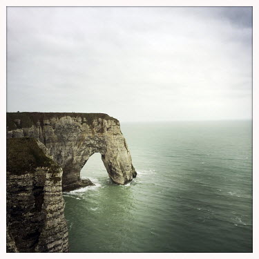 The Etretat chalk cliffs and a sea arch in the English Channel.
