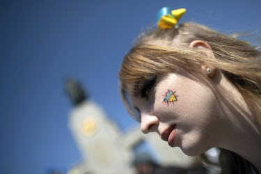 A Ukrainian woman with a heart-shaped Ukrainian flag drawn on her cheek at the Soviet war memorial in the Tiergarten on 8 May 2022, the 77th anniversary of the 1945 victory against Nazi Germany and th...