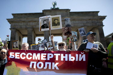 Russians with photos of Russian soldiers and relatives who fought, and in many cases died, in the Soviet army in World War II during a rally to commemorate the sacrifices of the Soviet Red Army on the...