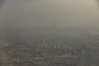 The skyline seen from an airplane through heavy smog.