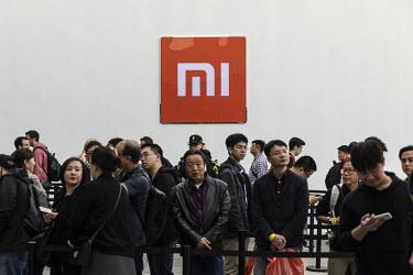 Fans wait in line outside a Xiaomi Corp smartphone unveiling event. Xiaomi Inc., is a Chinese designer and manufacturer of consumer electronics and related software, home appliances, and household ite...