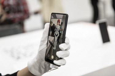 An attendee tests the augmented reality function of the Xiaomi Corp. Mi MIX 2S smartphone at an unveiling event. Xiaomi Inc., is a Chinese designer and manufacturer of consumer electronics and related...