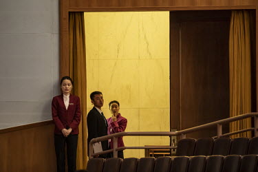 Attendants stand at an entrance during a voting session at the first session of the 13th National People's Congress (NPC) in the Great Hall of the People.
