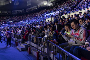 Fans attend a Xiaomi Corp smartphone unveiling event. Xiaomi Inc., is a Chinese designer and manufacturer of consumer electronics and related software, home appliances, and household items. Behind Sam...