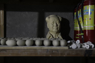 A bust of former Chinese leader Mao Zedong sits on a shelf inside a workshop at the Jingdezhen Porcelain Factory.