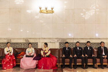 Delegates wearing ethnic minority costumes sit alongside attendants inside the Great Hall of the People ahead of the opening of the first session of the 13th Chinese People's Political Consultative Co...