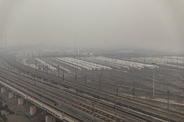 China Railway High-speed (CRH) trains, operated by China Railway Corp., sit in a train yard shrouded in haze on the outskirts of Shanghai.