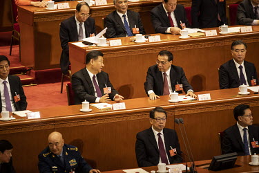 Chinese President Xi Jinping and Premier Li Keqiang chat with each other during a voting session at the first session of the 13th National People's Congress (NPC) at the Great Hall of the People.