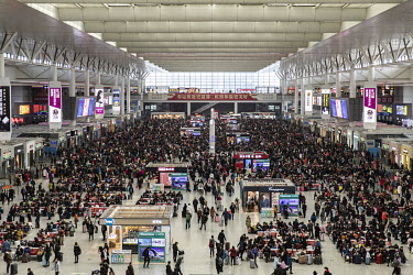Travellers pass through the Shanghai Hongqiao High-speed Railway Station.