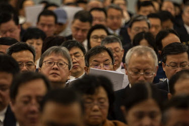 Delegates listen to s speech given during the opening of the first session of the 13th National People's Congress (NPC).