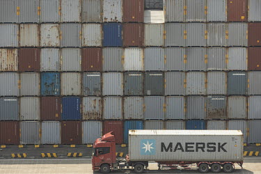Trucks move shipping containers in a terminal at the Yangshan Deep Water Port.