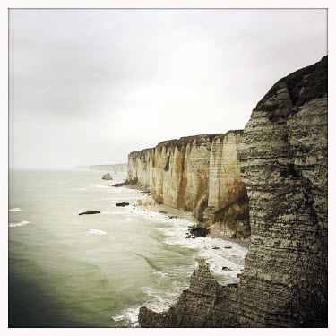The Etretat chalk cliffs overlooking the English Channel coastline.