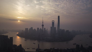 The Oriental Pearl Tower (centre left), Shanghai World Financial Center (centre), and the Shanghai Tower (centre right), stand among other buildings in the Lujiazui Financial District on the Pudong ri...