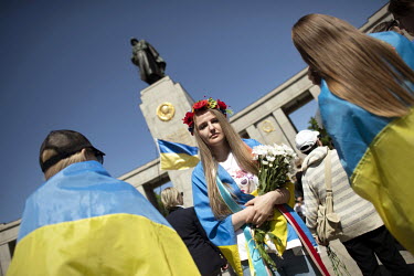 A group of Ukrainian women wrapped in their national flags at the Soviet war memorial in the Tiergarten on 8 May 2022, the 77th anniversary of the 1945 victory against Nazi Germany and the end of Worl...