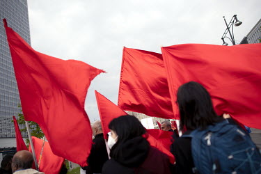 People carrying red flags at a May Day demonstration by various trades unions and left wing political groups.