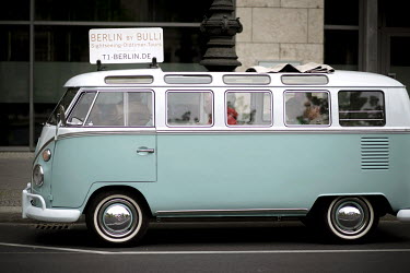 Tourists on a guided tour in an old VW bus as 'Berlin by Bulli Sightseeing Oldtimer Tours'.