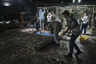 Volunteers make camouflage netting in a converted museum. Two nets were sent to Zaporizhzhia the day before and the ones being made today will be sent to Mariupol. Mykola, one of the coordinators said...