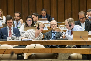 Russina diplomats including a member of the Russia delegation believed to be Boris Bondarev (right with glasses), Russia's counsellor to the United Nations in Geneva, photographed at open-ended Workin...