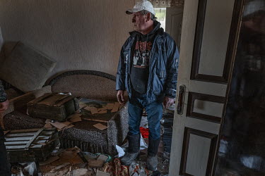 Grigory in his damaged house. The front room had been used as a toilet by Russian soldiers. "The enemy was in our village. They were killing us. We were also being bombed by our own side", he says.