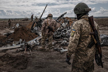 An army EOD team deal with rockets and rocket pods from a downed Russian MI-8 helicopter. Four bodies were sprawled amongst the wreckage. The helicopter was shot down near Makariv by Ukrainian forces...