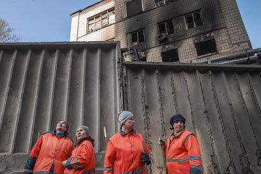 Workers clearing rubble after two cruise missiles landed in the night, killing a renowned Ukranian journalist and injuring a number of people.