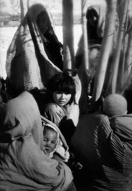 Women and children sheltering in a ditch from Taliban aerial bomb attack.