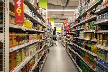 An employee stocks a shelf at a Walmart supermarket.