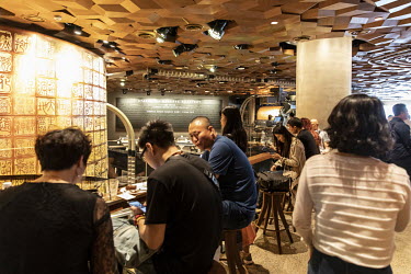 Customers crowd inside the Starbucks Corp. Reserve Roastery store.