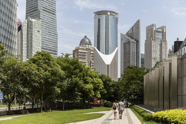 People walk through a park in Pudong'' Lujiazui financial district.