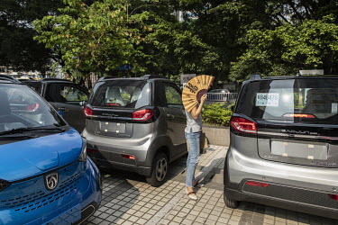 Potential customers check out the vehicles at a Wuling E1oo mini EV dealership. Wuling started out as a tractor factory, and then made its name with its cheap minivans and has now moved on to more sop...