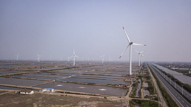 Wind turbines manufactured by Shanghai Electric Group Co. at a wind farm operated by China Huaneng Group.