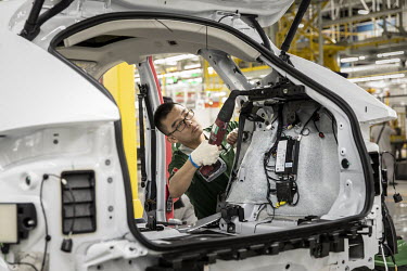 Employees assemble a Jaguar E-Pace compact sport utility vehicle (SUV) on the production line at the second phase of the Chery Jaguar Land Rover Automotive Co. plant. Jaguar Land Rover is building an...