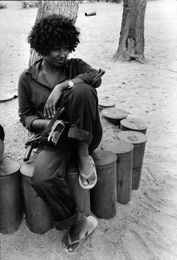 An Eritrean People's Liberation Front (EPLF) fighter with her weapon rests at a base camp following the Battle of Afabet fought the week before. It has been argued that the EPLF victory at Afabet was...