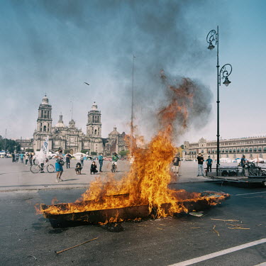 A traditional boat used in Xochimilco is burned during a protest in the historical of centre of Mexico City.