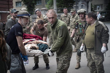 A civilian casualty is unloaded from a vehicle at an emergency hospital receiving wounded from the artillery battle now raging for the the towns of Sievierodonetsk and Lysychansk. They are dealing wit...