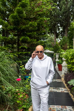 Asil Nadir in the garden of his luxury villa (formerly a nunnery).
