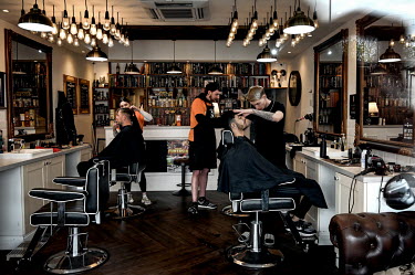 Oliver Henry (pictured centre) and his staff cut hair in Chaps Barbers, a local business in Brandlesholme.  Local elections are due in the political constituency of Bury North on 27 April 2022, a trad...