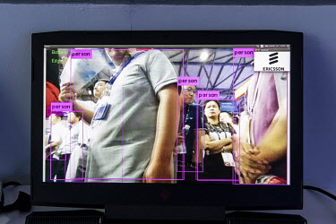 A screen displays a demonstration of facial recognition software at the Ericsson AB booth at the Mobile World Congress.