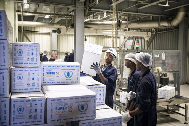 Staff packing the finished product at Africa Improved Foods, a Rwandan company with a Dutch shareholder, DSM. At the Kigali factory they make a special breakfast porridge using locally bought corn des...