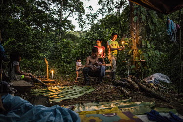 A group set up a camp in the forest.Setting up a camp can take up to an hour, often ending with the arrival of nightfall.