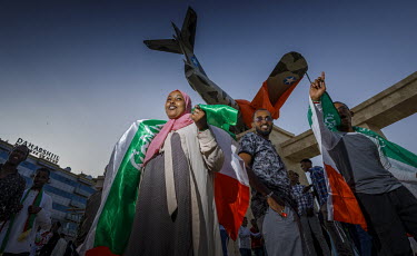 People gather beneath an inflatable MIG fighter plane which forms part of the 31st independence day celebrations. During the late 1980s it was this type of aeroplane that completely destroyed Hargeisa...