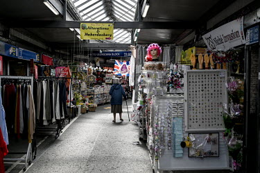 A woman walks through the busy market in the centre of town.  Local elections are due in the political constituency of Bury North on 27 April 2022, a traditionally Labour Party seat that turned to vot...