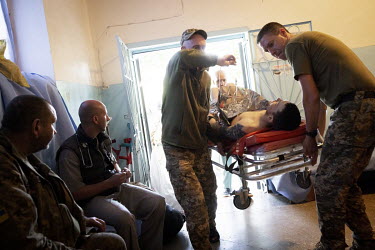 A severely wounded soldier taken directly on arrival to the operating theatre at a military hospital in an undisclosed location close to the frontline in Donetsk. Most have been wounded by shrapnel fr...