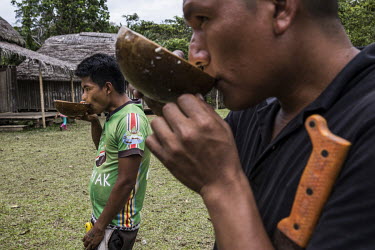Men drinking 'Chicha, ak'a in Quechua', an Andean drink found in Ecuador, Peru, Bolivia, Venezuela and Colombia. It is made from corn, peanuts (mani), cassava (yuca) or rice (arroz) to which fruit is...