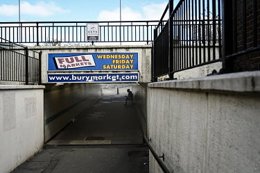 A man busks in a pedestrian underpass leading to the busy market in the centre of town.  Local elections are due in the political constituency of Bury North on 27 April 2022, a traditionally Labour Pa...